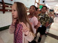 First grader Eliana Prez, 6, leads her classmates with the quite sign as she and fellow John Devalles elementary school first graders proceed to their next class during their first day of school.  [ PETER PEREIRA/THE STANDARD-TIMES/SCMG ]